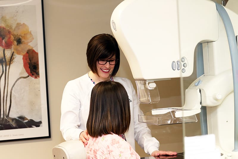 Patient getting a mammogram with friendly provider